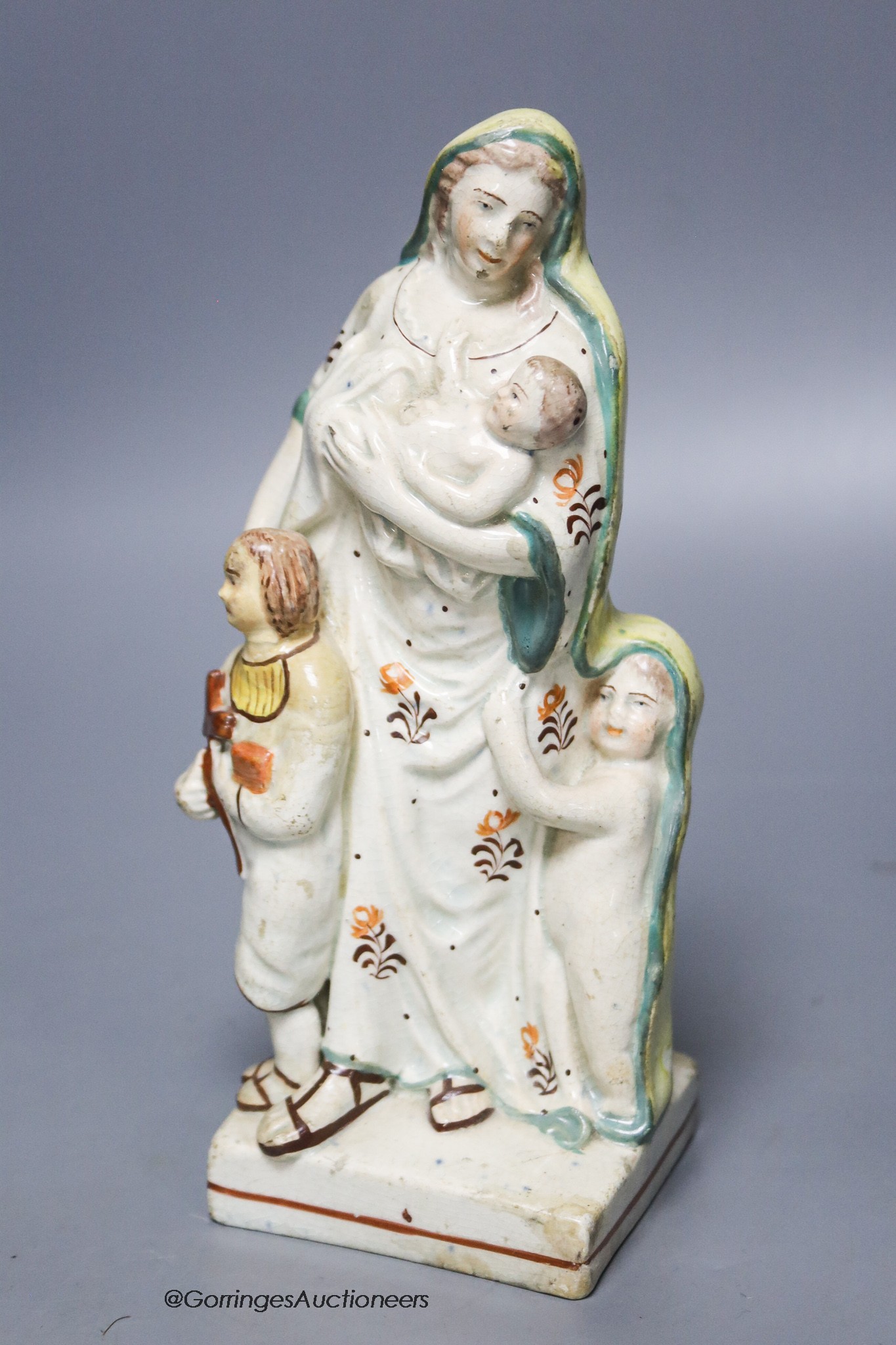 A Staffordshire pearlware group of a mother and children, c.1800, height 19cm